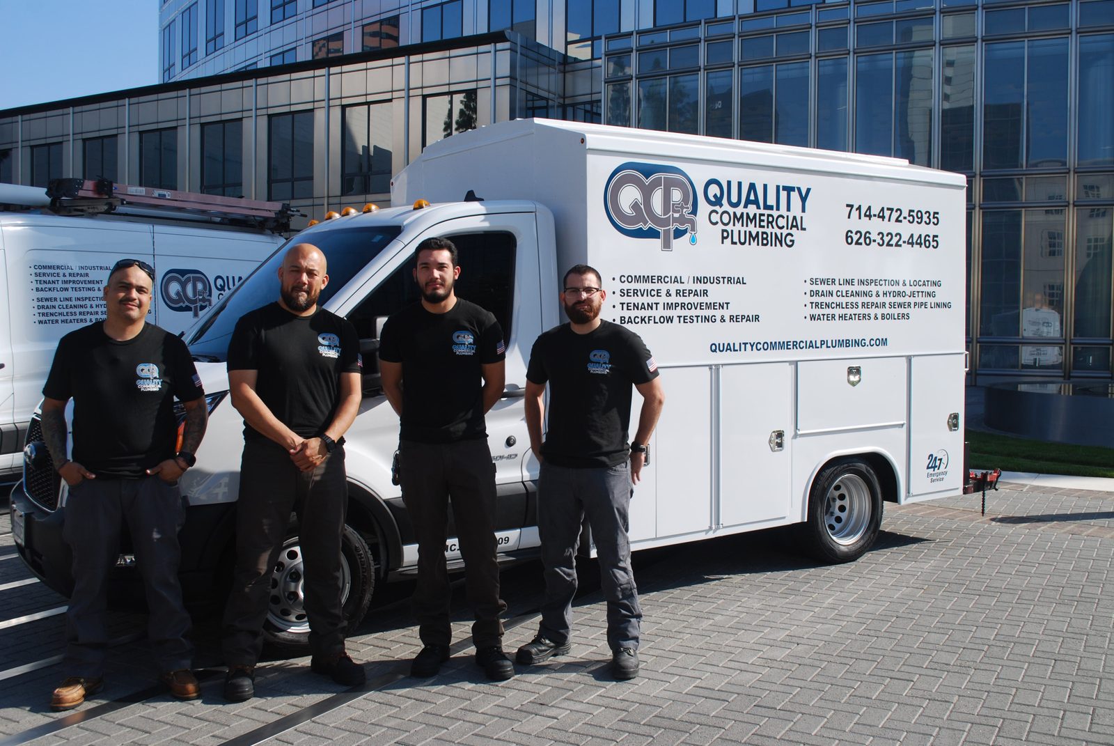 Quality Commercial Plumbing technicians and service van at a commercial building